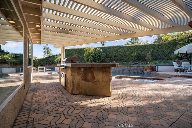 view of patio / terrace featuring grilling area, a jacuzzi, an outdoor kitchen, and a swimming pool