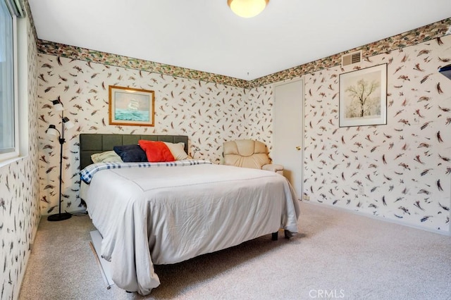bedroom with visible vents, carpet floors, and wallpapered walls