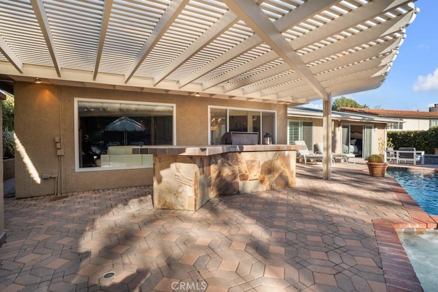 view of patio with an outdoor pool, outdoor dry bar, and a pergola