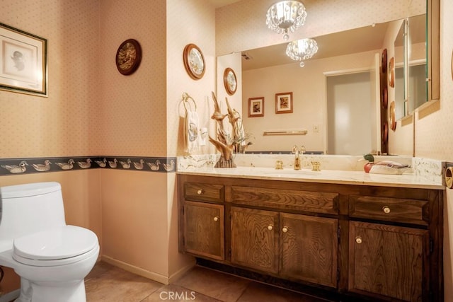 bathroom featuring vanity, toilet, tile patterned flooring, and wallpapered walls