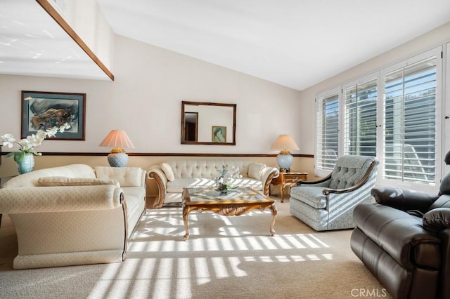 living room featuring carpet floors and vaulted ceiling