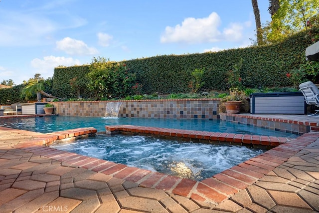view of pool featuring a fenced in pool and an in ground hot tub