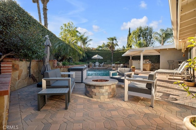view of patio featuring an outdoor fire pit and an outdoor kitchen