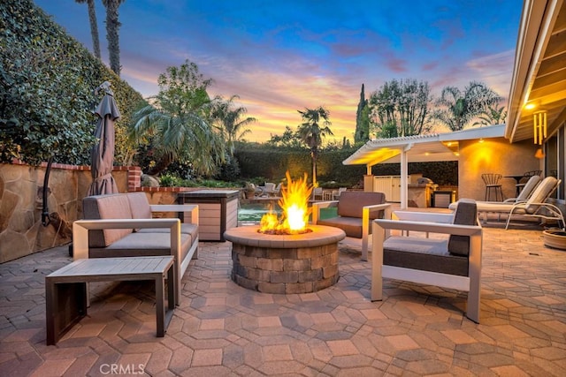 view of patio featuring an outdoor living space with a fire pit and an outdoor kitchen