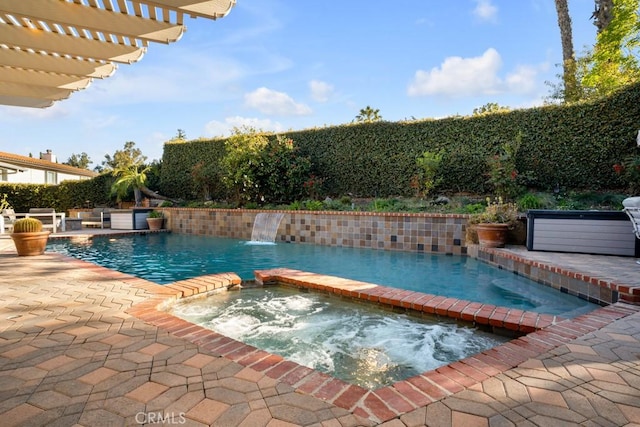 view of pool with a fenced in pool, a patio area, and an in ground hot tub