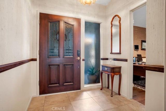 tiled foyer entrance featuring baseboards