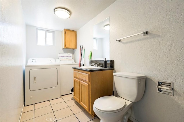 609 Rancheria Dr, Chico, CA 95926 - bathroom with washer and dryer, vanity, tile patterned floors, plenty of natural light, and a textured wall