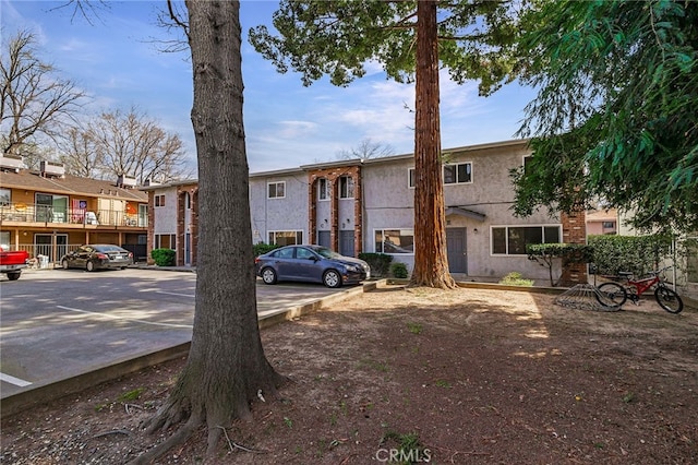 609 Rancheria Dr, Chico, CA 95926 - view of front facade with uncovered parking and stucco siding