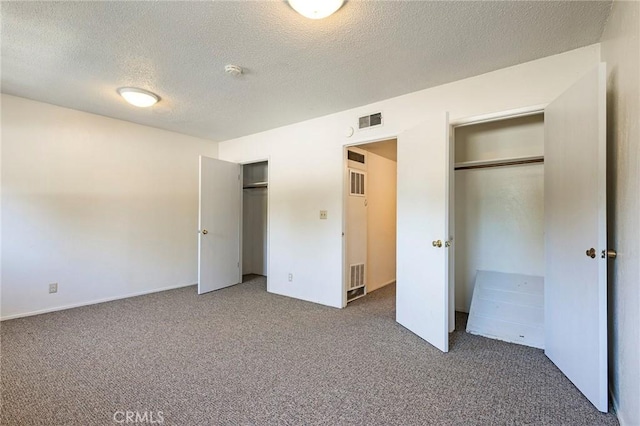 609 Rancheria Dr, Chico, CA 95926 - unfurnished bedroom with carpet flooring, a textured ceiling, and multiple closets