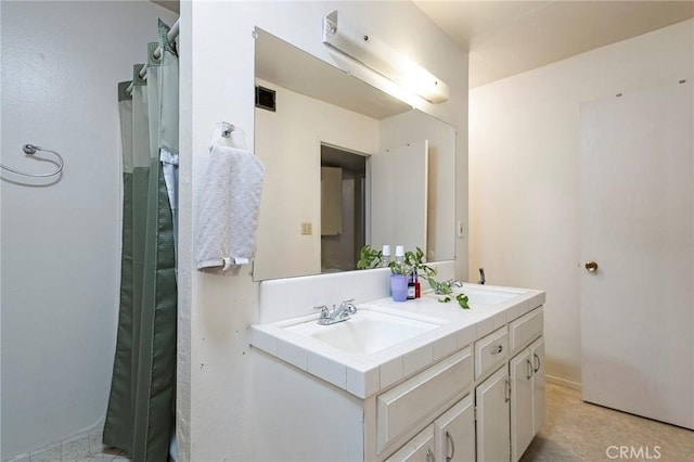 full bath with a sink and double vanity
