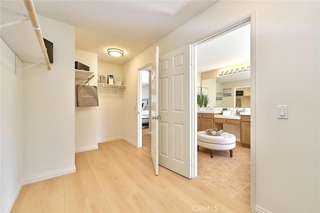 4224 Castlepeak Dr, Corona, CA 92883 - walk in closet with light wood-style floors