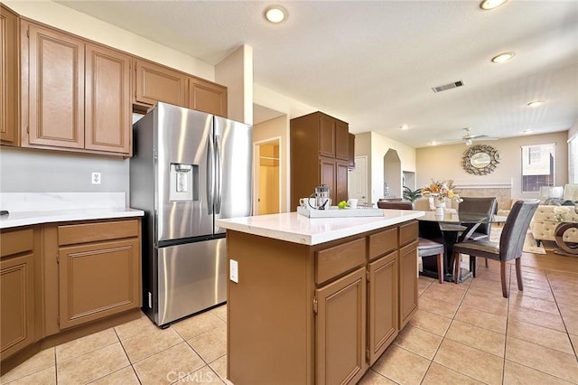 4224 Castlepeak Dr, Corona, CA 92883 - kitchen featuring visible vents, stainless steel fridge, light tile patterned floors, and open floor plan