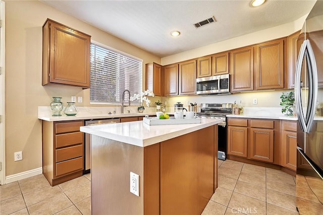 4224 Castlepeak Dr, Corona, CA 92883 - kitchen with light countertops, stainless steel appliances, a sink, visible vents, and brown cabinets