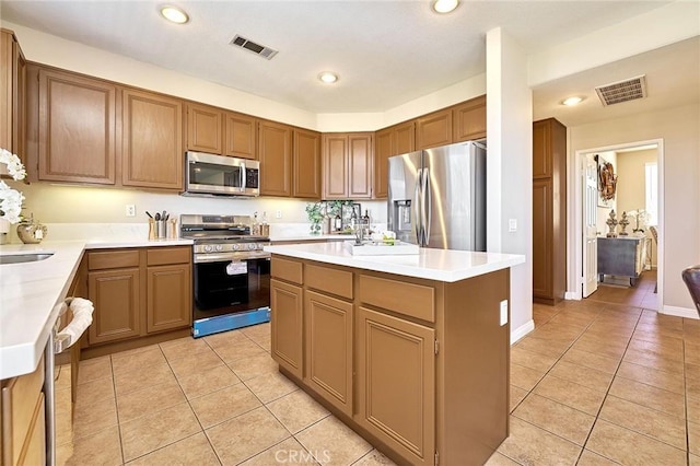 4224 Castlepeak Dr, Corona, CA 92883 - kitchen with light tile patterned flooring, appliances with stainless steel finishes, recessed lighting, and visible vents