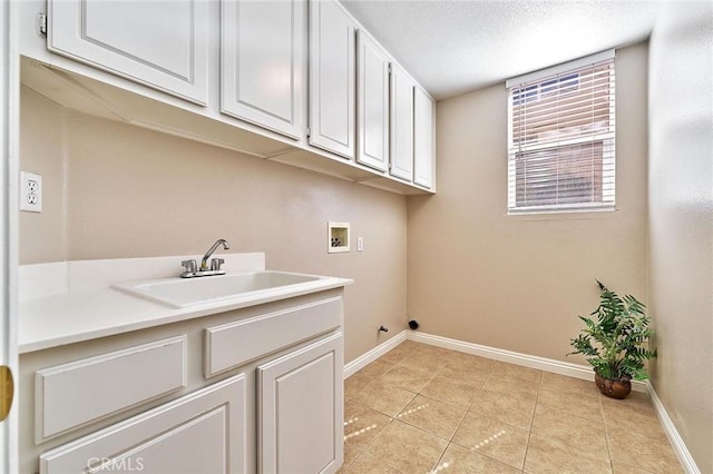 4224 Castlepeak Dr, Corona, CA 92883 - laundry room featuring light tile patterned floors, hookup for a washing machine, baseboards, a sink, and cabinet space