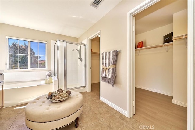 4224 Castlepeak Dr, Corona, CA 92883 - bathroom with a shower stall, a walk in closet, a bath, baseboards, and visible vents