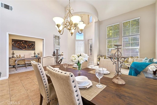 4224 Castlepeak Dr, Corona, CA 92883 - dining space featuring an inviting chandelier, light tile patterned flooring, arched walkways, a towering ceiling, and visible vents