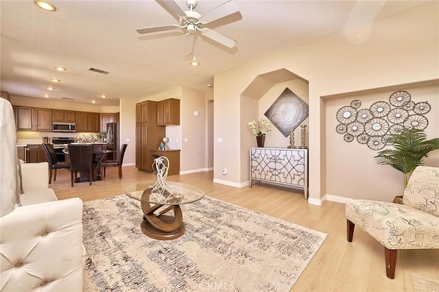 4224 Castlepeak Dr, Corona, CA 92883 - living area with a ceiling fan, baseboards, light wood-style floors, and visible vents