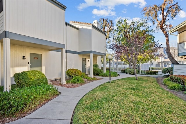 view of community featuring a residential view and a yard