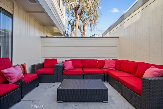 view of patio with fence and outdoor lounge area