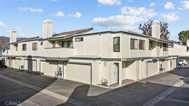 exterior space featuring a chimney and a balcony