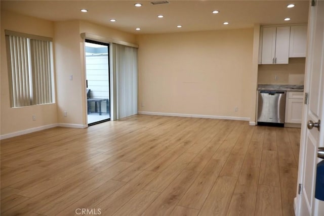 unfurnished living room featuring baseboards, light wood-type flooring, and recessed lighting