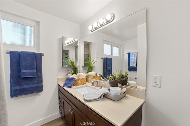 bathroom with baseboards and vanity