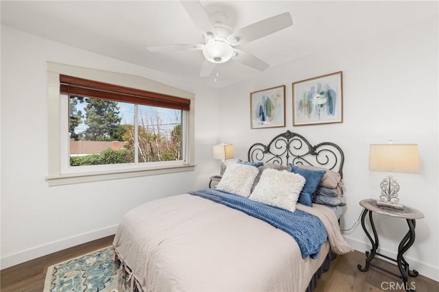 bedroom featuring wood finished floors, ceiling fan, and baseboards