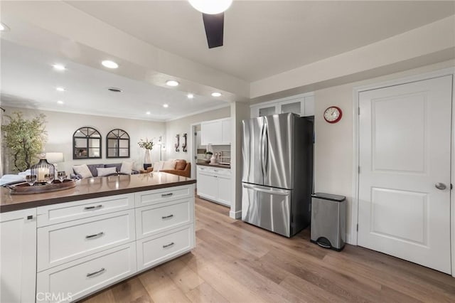 kitchen featuring dark countertops, freestanding refrigerator, recessed lighting, white cabinetry, and light wood finished floors