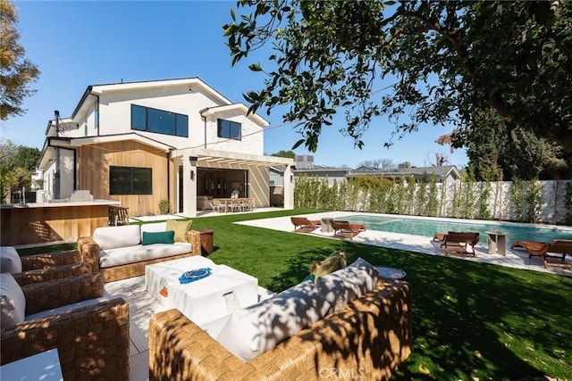 back of property featuring a lawn, an outdoor pool, outdoor dry bar, a patio, and outdoor lounge area