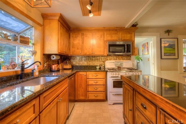 13730 Nimshew Rd, Magalia, CA 95954 - kitchen featuring a sink, dark stone countertops, stainless steel appliances, brown cabinetry, and decorative backsplash