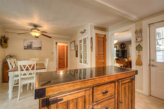 13730 Nimshew Rd, Magalia, CA 95954 - kitchen featuring a ceiling fan, dark countertops, and brown cabinetry