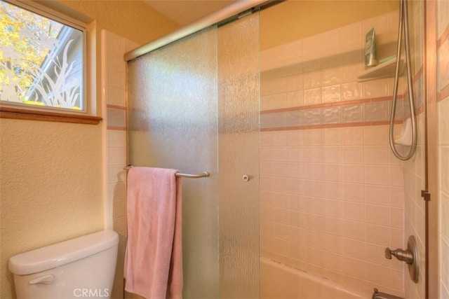 13730 Nimshew Rd, Magalia, CA 95954 - bathroom with toilet, a textured wall, and combined bath / shower with glass door