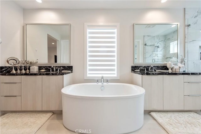 121 Mulberry, Lake Forest, CA 92630 - bathroom featuring a freestanding tub, a marble finish shower, tile patterned flooring, two vanities, and recessed lighting
