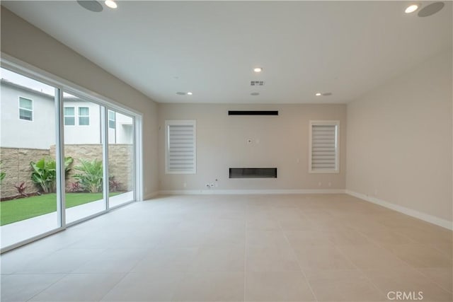 121 Mulberry, Lake Forest, CA 92630 - unfurnished living room with recessed lighting and a glass covered fireplace