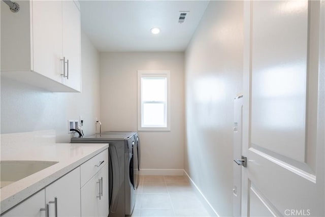 121 Mulberry, Lake Forest, CA 92630 - washroom featuring separate washer and dryer, cabinet space, light tile patterned floors, and recessed lighting