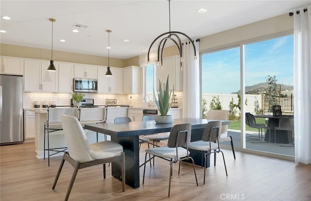 29754 Laurel Ct, Menifee, CA 92584 - dining space with visible vents, a mountain view, recessed lighting, and light wood-type flooring