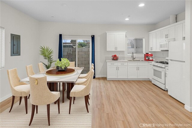 1109 N Mulberry, Compton, CA 90222 - kitchen with white appliances, electric panel, light wood-style floors, white cabinetry, and recessed lighting
