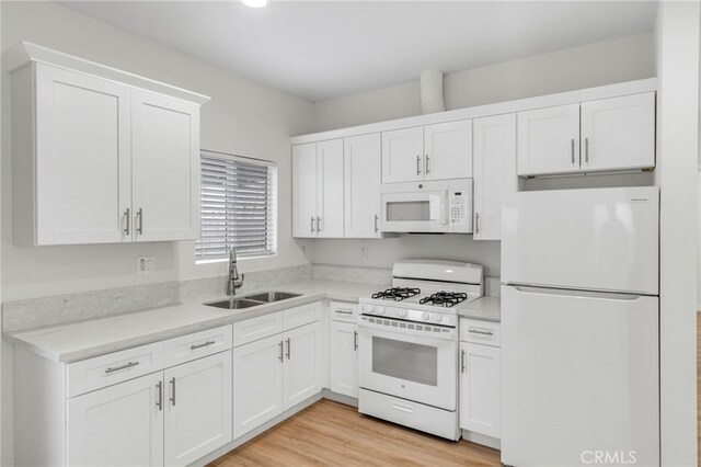 1109 N Mulberry, Compton, CA 90222 - kitchen with white appliances, white cabinetry, and light countertops