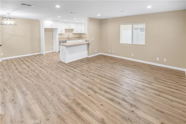 1109 N Mulberry, Compton, CA 90222 - unfurnished living room with light wood-type flooring, recessed lighting, and a chandelier