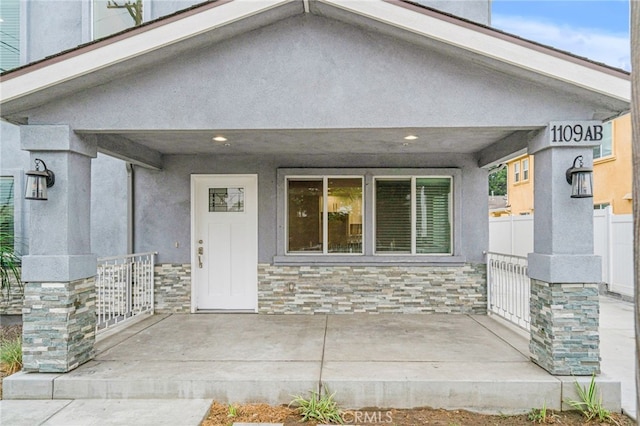 1109 N Mulberry, Compton, CA 90222 - doorway to property featuring stone siding, a porch, and stucco siding