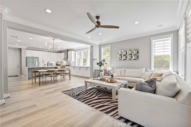 3905 Elderberry Cir, Corona, CA 92882 - living room with ornamental molding, ceiling fan with notable chandelier, and light wood finished floors