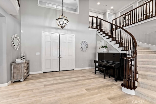 3905 Elderberry Cir, Corona, CA 92882 - entryway featuring baseboards, wood finished floors, a chandelier, and stairway