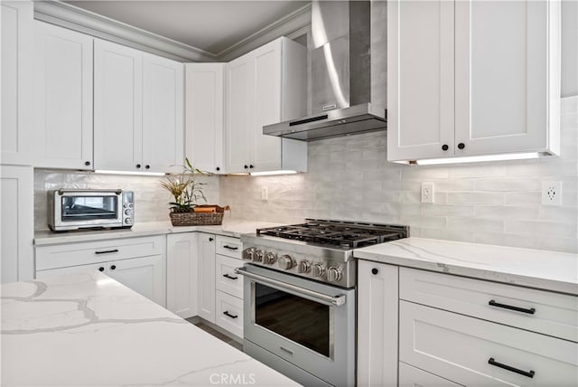 3905 Elderberry Cir, Corona, CA 92882 - kitchen featuring white cabinetry, backsplash, light stone counters, high end range, and wall chimney exhaust hood