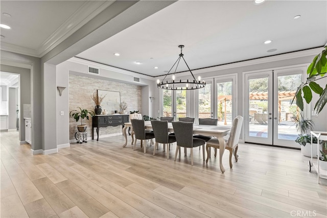 3905 Elderberry Cir, Corona, CA 92882 - dining space with french doors, ornamental molding, light wood finished floors, visible vents, and a notable chandelier