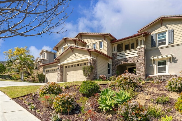 3905 Elderberry Cir, Corona, CA 92882 - view of front of property featuring stone siding, a balcony, concrete driveway, and an attached garage