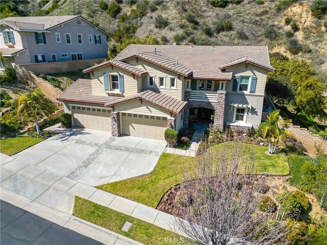 3905 Elderberry Cir, Corona, CA 92882 - view of front of property featuring stone siding, a tiled roof, an attached garage, concrete driveway, and a front lawn