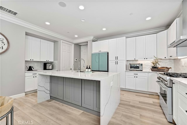 3905 Elderberry Cir, Corona, CA 92882 - kitchen with high end range, fridge, light wood-style floors, and visible vents