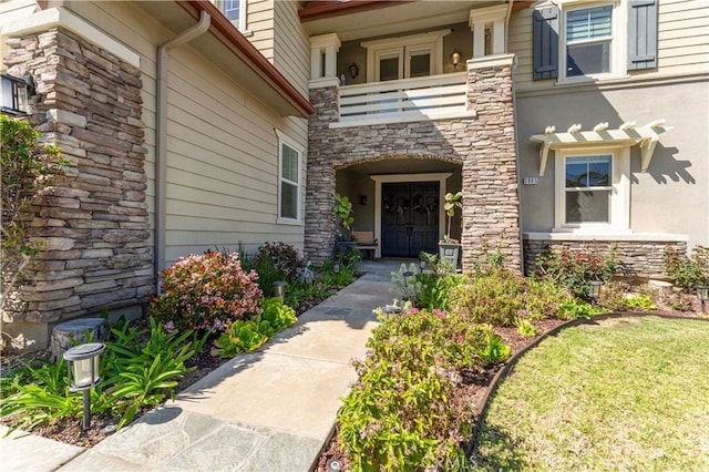 3905 Elderberry Cir, Corona, CA 92882 - doorway to property featuring stone siding, a balcony, and stucco siding