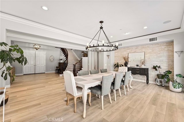 3905 Elderberry Cir, Corona, CA 92882 - dining room featuring crown molding, stairway, light wood-type flooring, an inviting chandelier, and visible vents